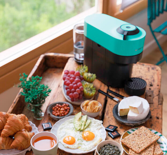 Máquina de Nespresso y bandeja con alimentos de desayuno