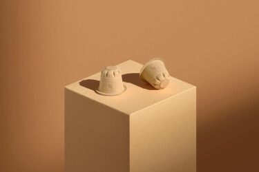 Two compostable Nespresso coffee capsules